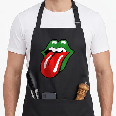 Tablier de cuisine noir avec une illustration colorée de lèvres vertes et d'une langue rouge saillante au centre du torse.