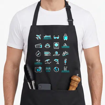 Tablier de cuisine noir avec des icônes de voyage en blanc et turquoise incluant un avion, un billet et un globe terrestre.