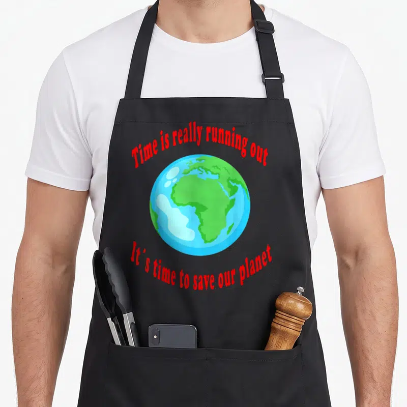 Tablier de cuisine noir avec une illustration colorée de la Terre et des textes rouges en anglais.
