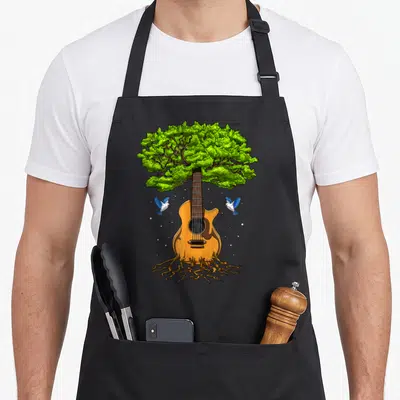 Tablier de cuisine noir avec illustration d'une guitare acoustique dont la partie supérieure devient un arbre aux feuilles vertes et des racines.