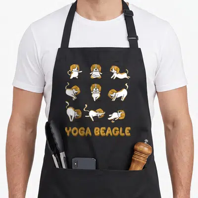Tablier de cuisine noir avec neuf beagles effectuant des postures de yoga sous le texte Yoga Beagle doré.