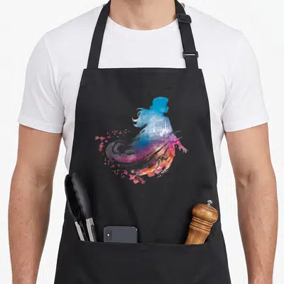 Tablier de cuisine noir avec silhouette aquatique colorée d'Anna Wind et château en arrière-plan.
