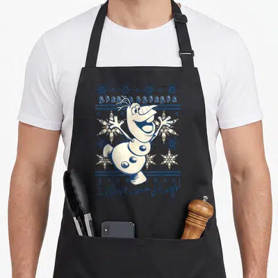 Tablier de cuisine noir avec Olaf et le texte I Love warm Hugs entouré de flocons de neige bleus et blancs.