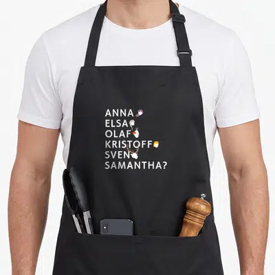 Tablier de cuisine noir avec les noms Anna, Elsa, Olaf, Kristoff, Sven et Samantha accompagnés de leurs têtes stylisées.